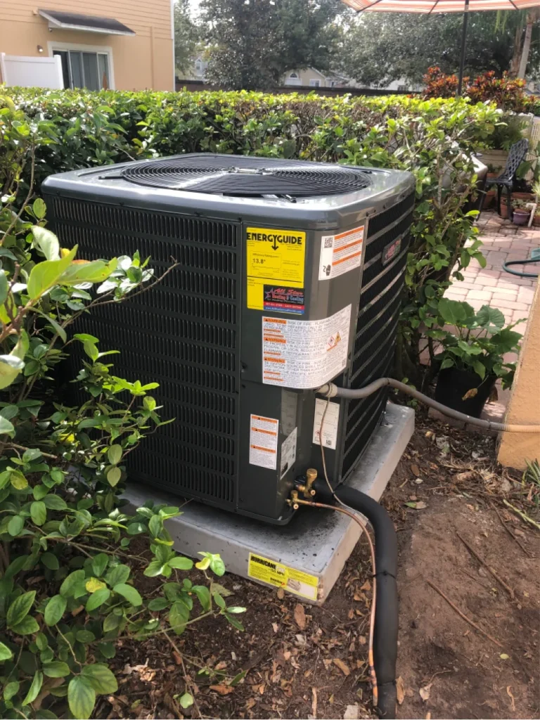 HVAC technician inspecting and servicing an outdoor air conditioning unit